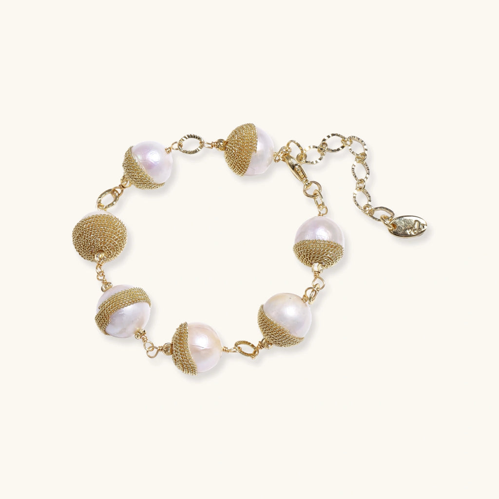 Adjustable bracelet with baroque pearls wrapped in delicate gold mesh netting connected by textured chain links