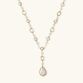 Long gold-plated necklace with alternating freshwater pearls and crystal bezels, featuring a large baroque pearl pendant