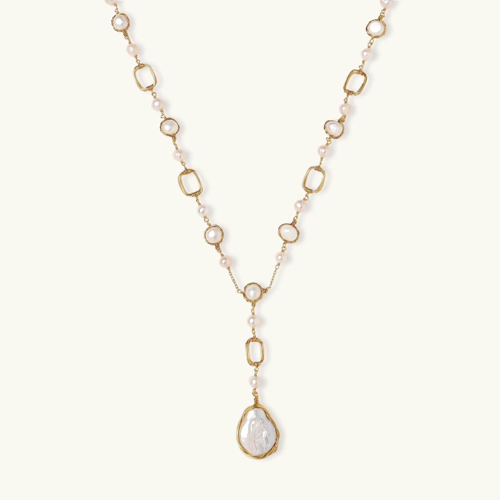 Long gold-plated necklace with alternating freshwater pearls and crystal bezels, featuring a large baroque pearl pendant