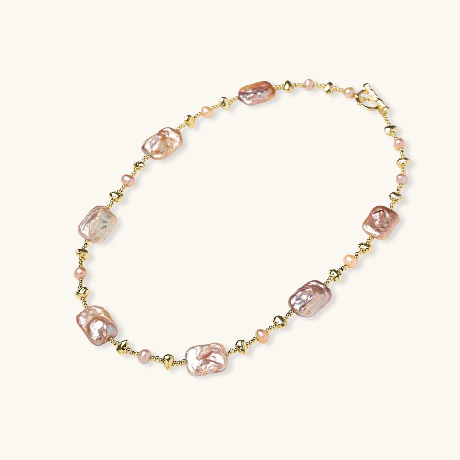 Iridescent baroque pearls alternating with small freshwater pearls on 14K gold-plated chain