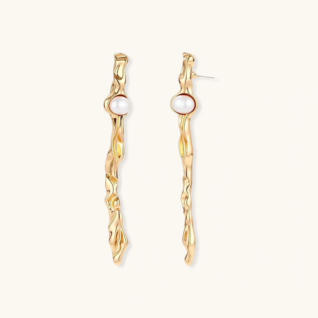 Organic twisted gold-toned drop earrings with white ABS pearls positioned near the top on cream background.