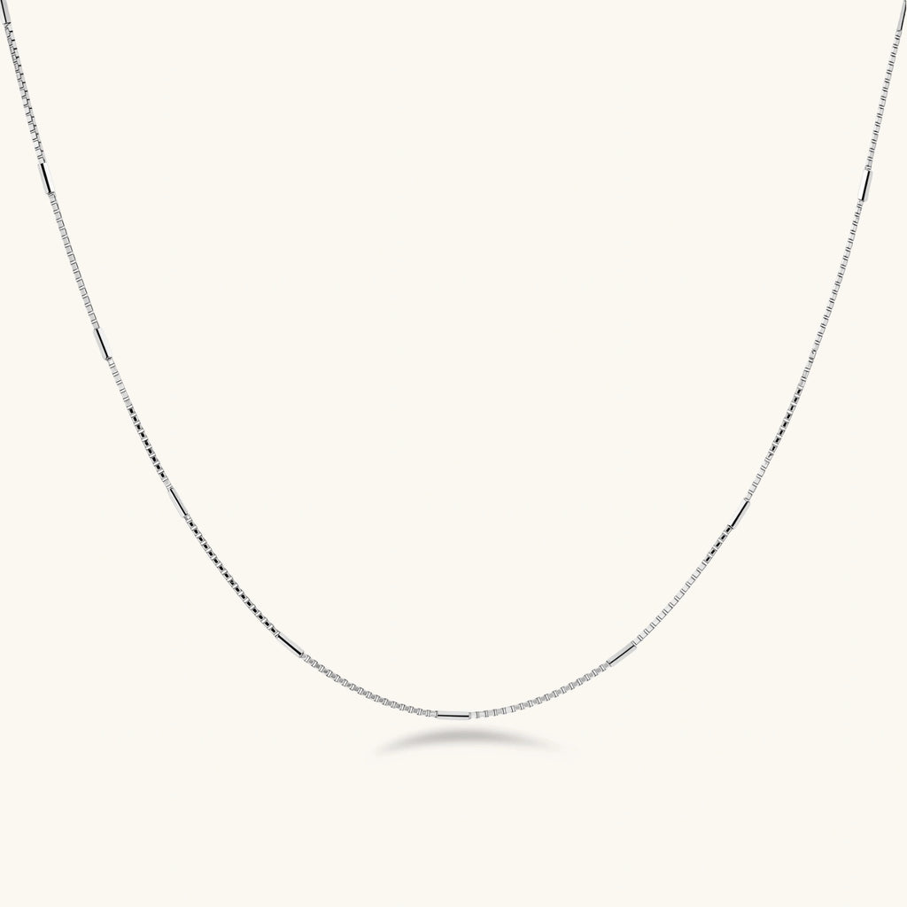 Delicate platinum-plated sterling silver necklace with alternating textured cubic links and smooth chain sections.