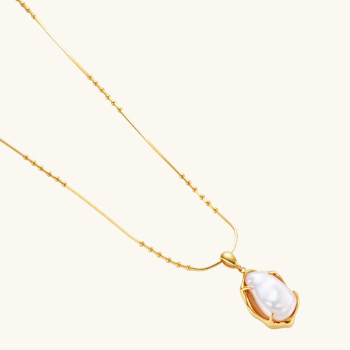 18K gold-plated sterling silver necklace with alternating bead chain and baroque pearl pendant on neutral background.