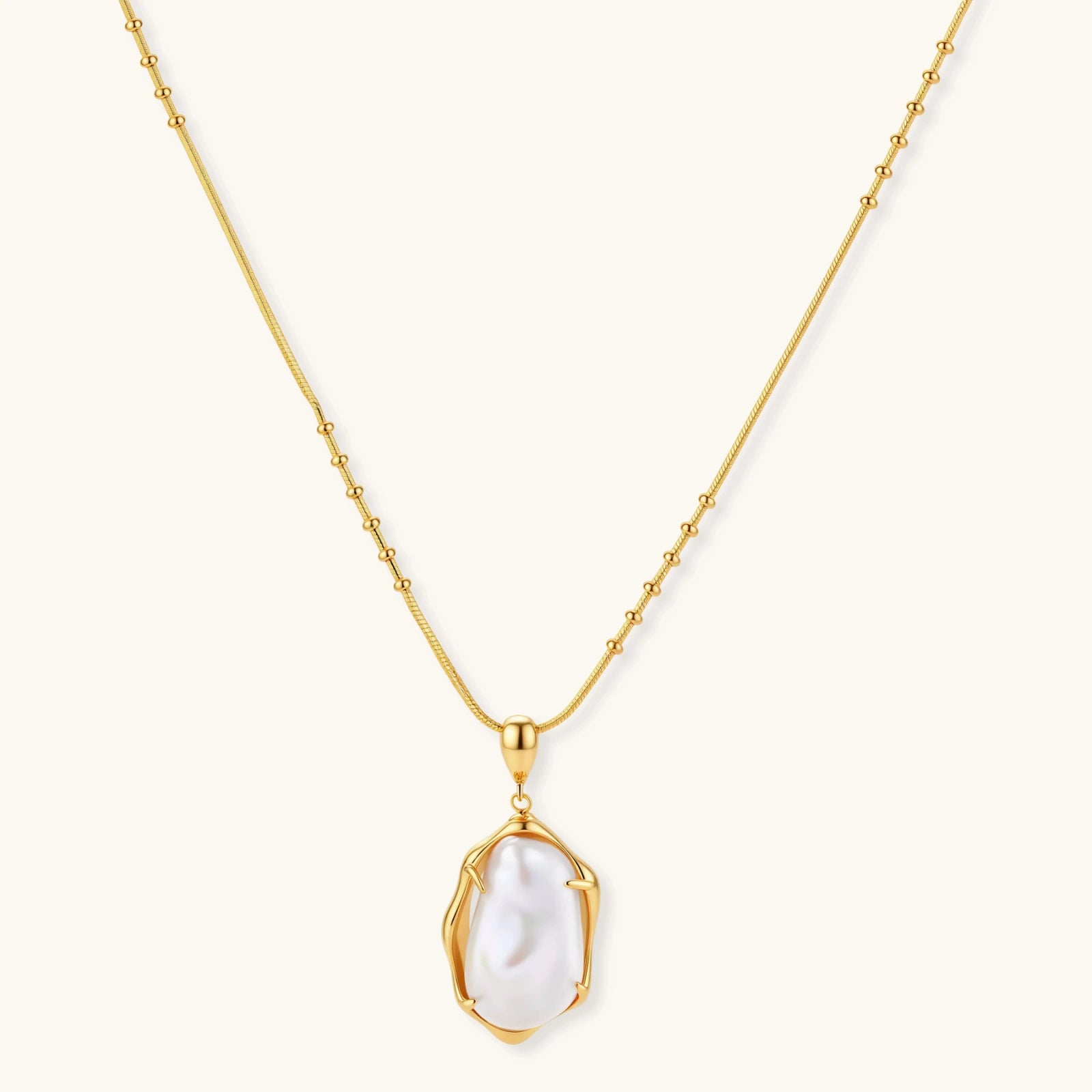 18K gold-plated sterling silver necklace with alternating bead chain and baroque pearl pendant on neutral background.