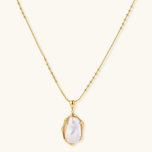 18K gold-plated sterling silver necklace with alternating bead chain and baroque pearl pendant on neutral background.