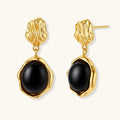 Gold-plated rippled stud earrings with black agate stone drops on white background