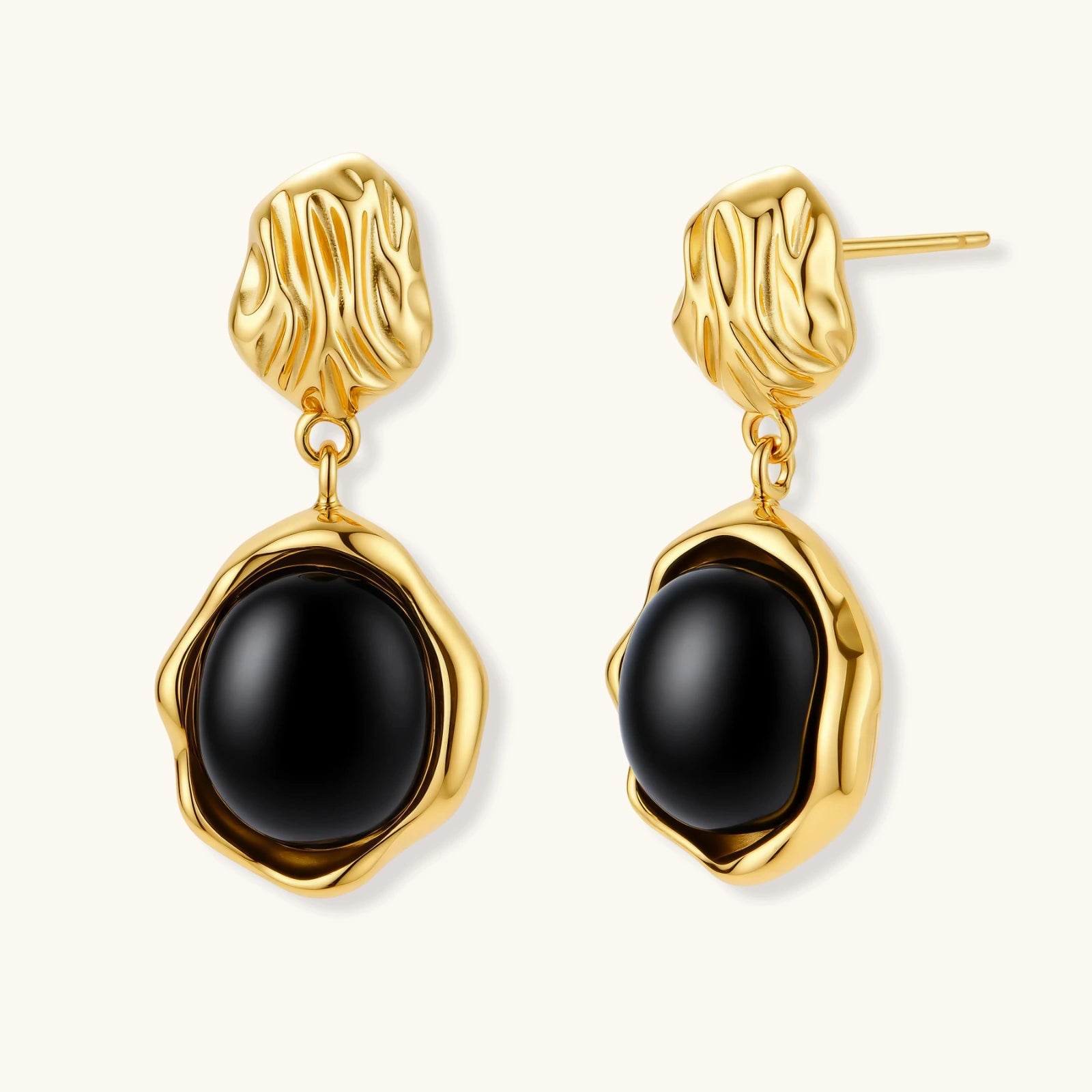 Gold-plated rippled stud earrings with black agate stone drops on white background