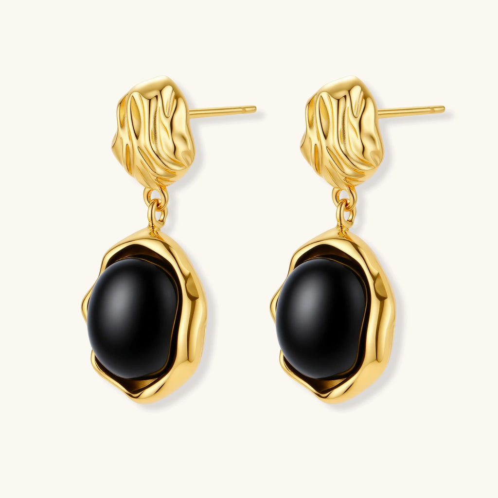 Gold-plated rippled stud earrings with black agate stone drops on white background