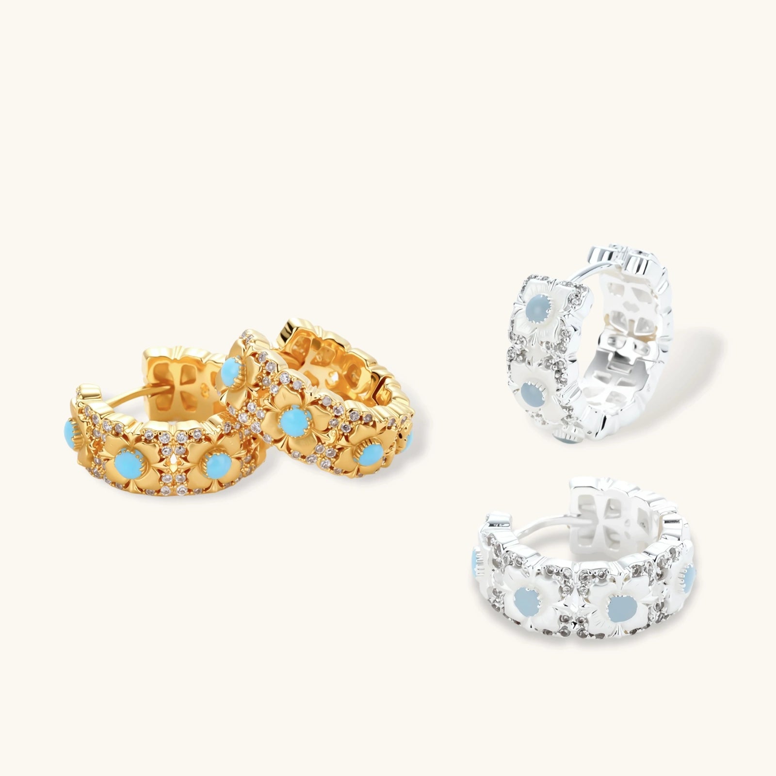 Silver-plated hoop earrings featuring delicate daisy flowers with powder blue centers and crystal accents on white background.