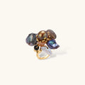 Adjustable gold-plated ring featuring clustered dark baroque pearls in organic arrangement on white background.