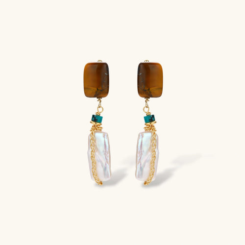 Gold-plated drop earrings with amber stones, teal beads, and wire-wrapped baroque pearls on cream background.