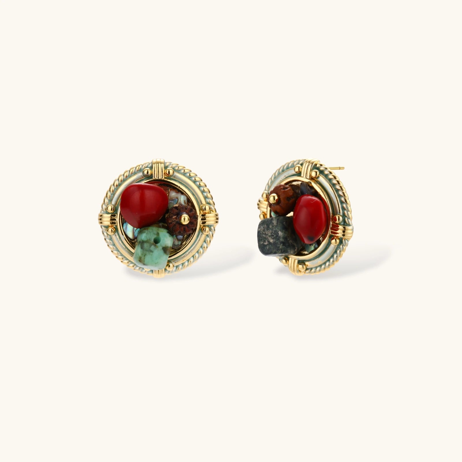 Circular gold-plated earrings with turquoise, coral, wood beads, and rope border detail on cream background.