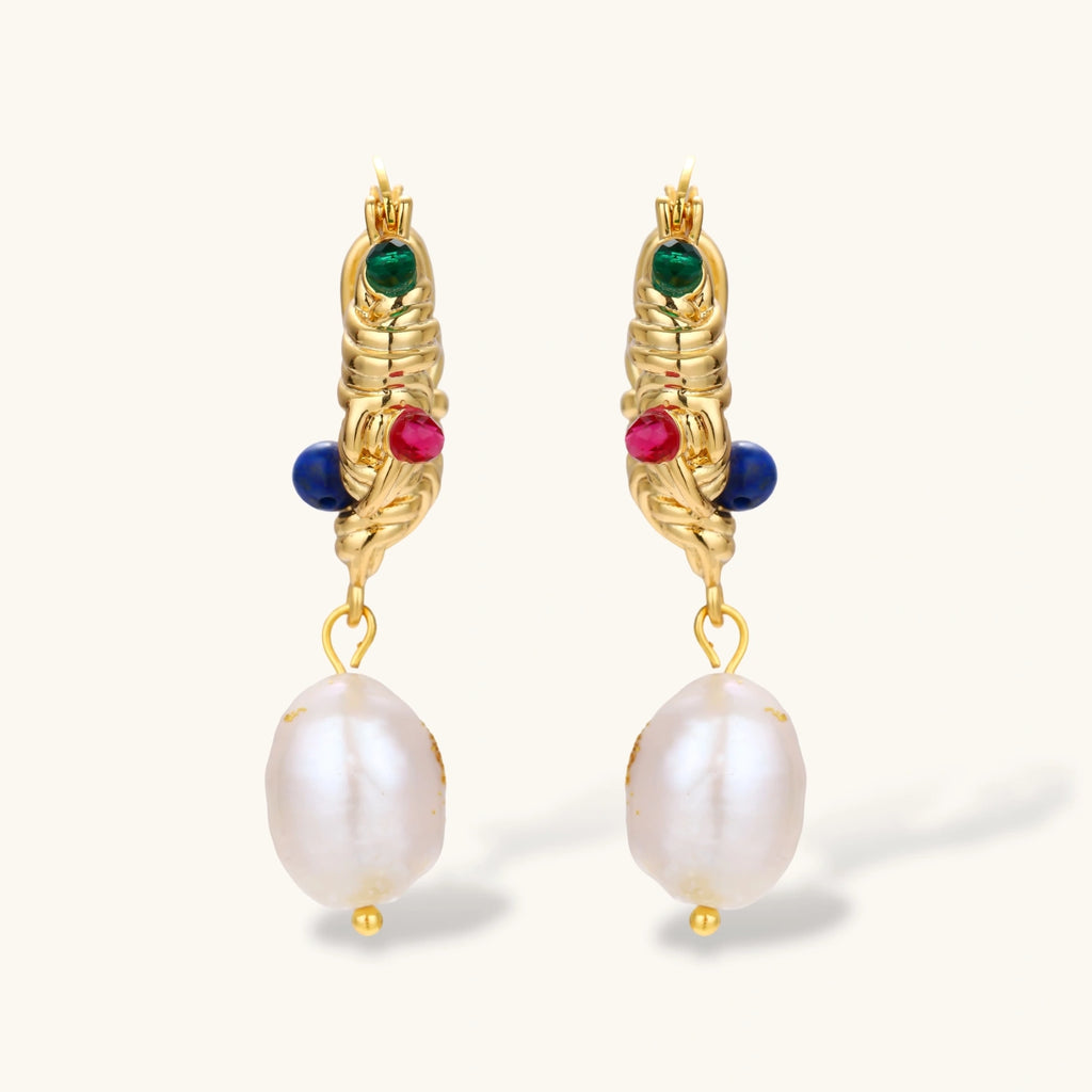 Ornate gold-plated hoop earrings with emerald, ruby, and sapphire accents, featuring dangling baroque freshwater pearls