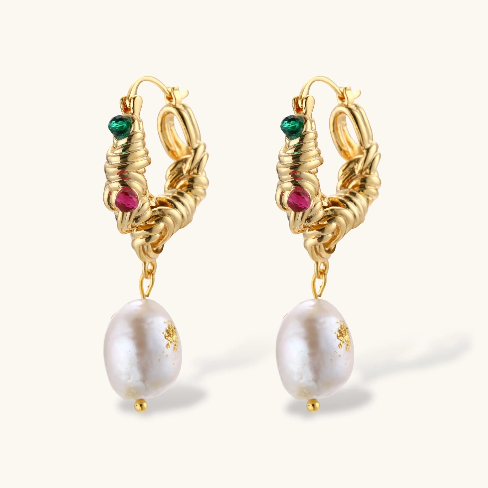 Ornate gold-plated hoop earrings with emerald, ruby, and sapphire accents, featuring dangling baroque freshwater pearls