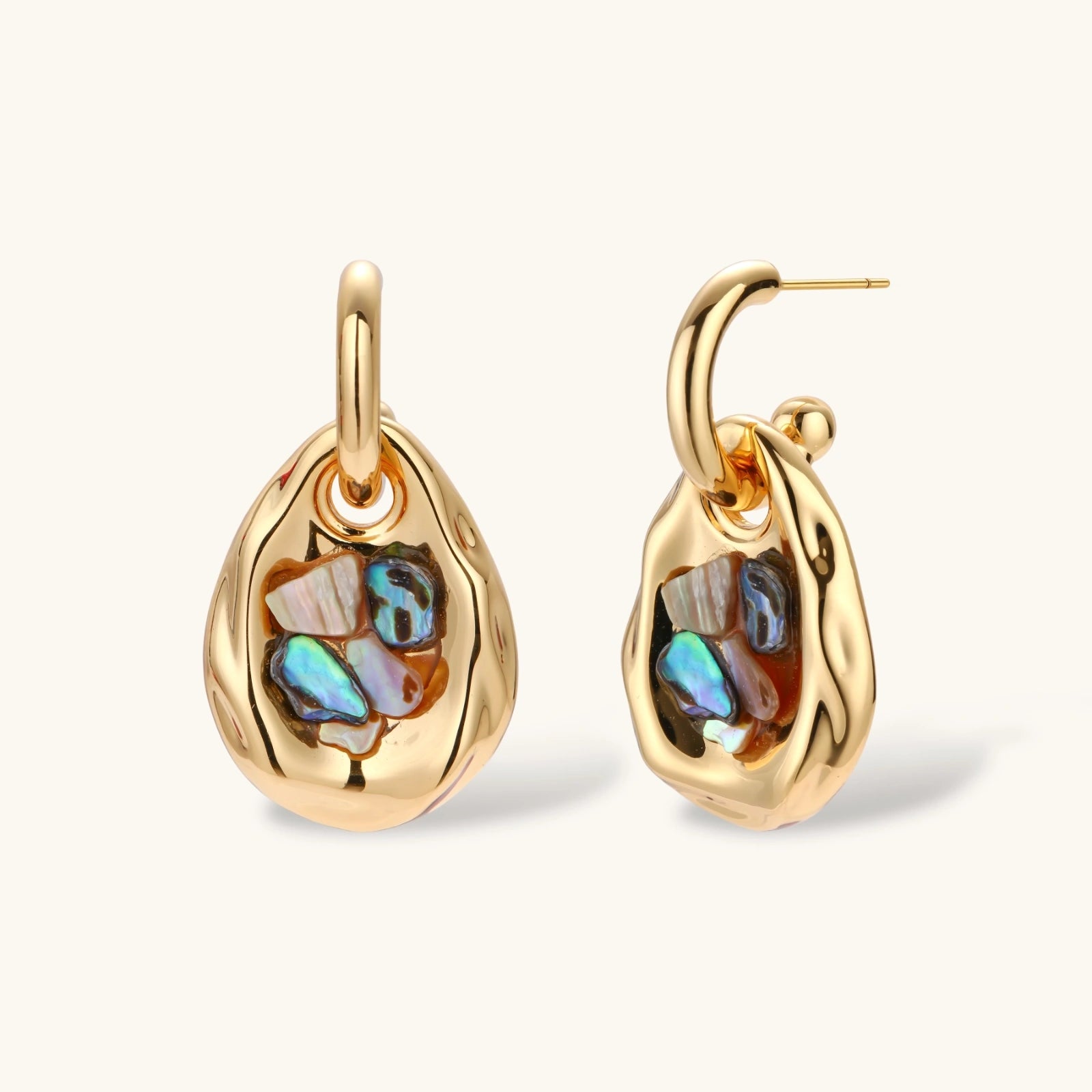 Gold-plated convertible hoop earrings with iridescent shell mosaic pendants, shown assembled and separated on cream background.