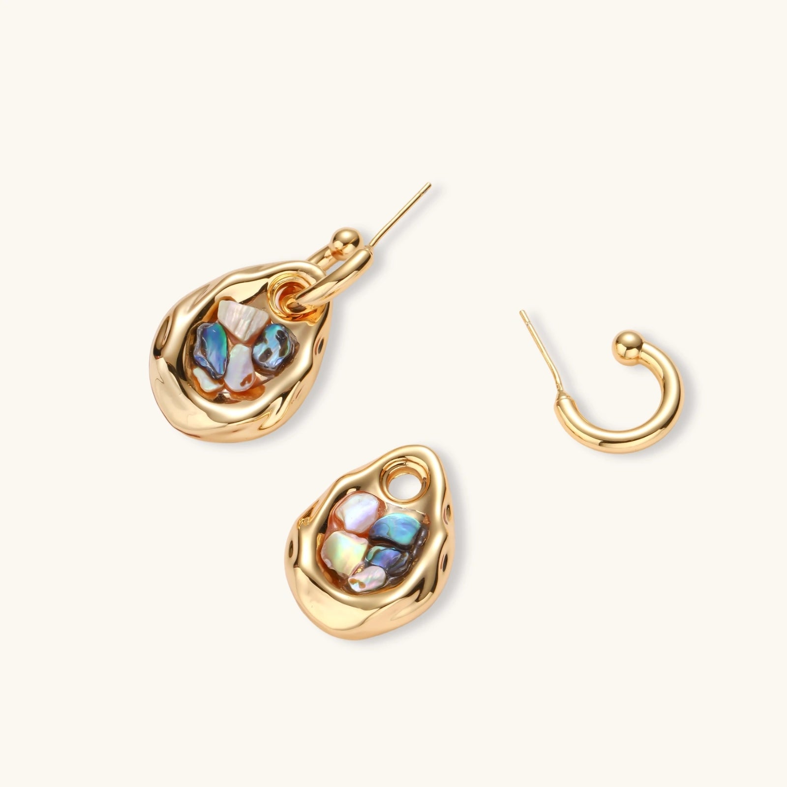 Gold-plated convertible hoop earrings with iridescent shell mosaic pendants, shown assembled and separated on cream background.