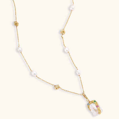 Delicate 18k gold-plated chain with baroque pearls and colorful enamel pendant featuring blue, pink accents on cream background.