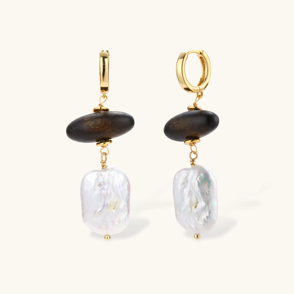 Gold hoop earrings with dark wood beads and baroque freshwater pearls, shown from multiple angles on cream background.