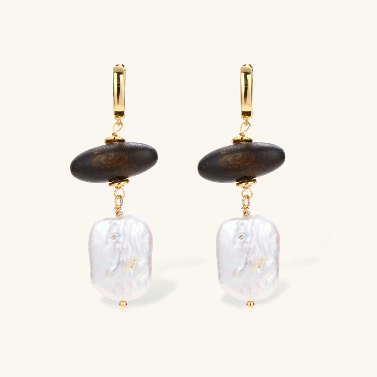 Gold hoop earrings with dark wood beads and baroque freshwater pearls, shown from multiple angles on cream background.
