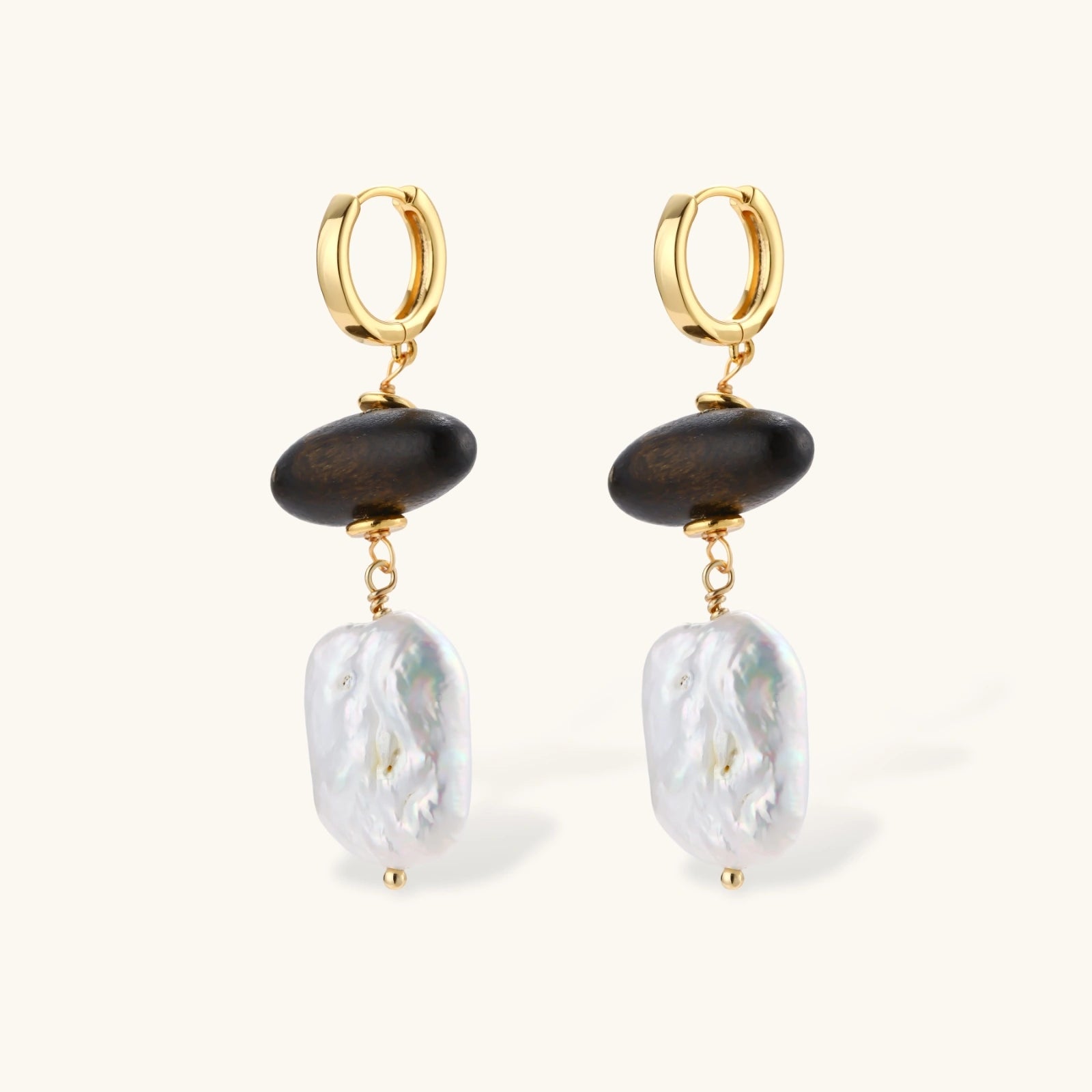 Gold hoop earrings with dark wood beads and baroque freshwater pearls, shown from multiple angles on cream background.
